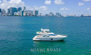 Luxury Yacht Azimut 55-ft. White Azimut Yacht Flybridge on the water in Miami next to small picnic Island