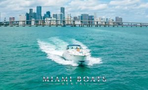 42 feet Sea Ray yacht splashing the ocean. Miami Downtown on the horizon.