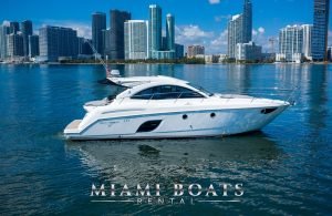 The 46' Beneteau yacht on the water with the Downtown Miami on the background.