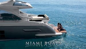 Couple sitting on the swimming platform of the 55' Azimut Sport luxury yacht.