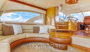 Leather couch and table in the main salon of the 55' Azimut wine down yacht.