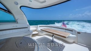 The aft deck of the 55' Sea Ray yacht. Leather couches and table.