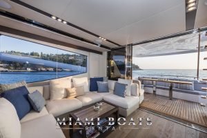 Couch and table in the main salon and the Aft deck of the 65' Numarine luxury yacht.