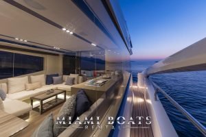 The right side of the 65' Numarine luxury yacht in the sunset hour.