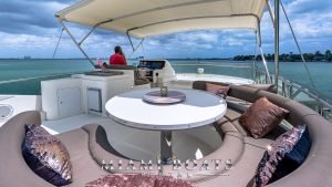 Round couch and round table on the Flybridge of the 70' Ferretti Luxury Yacht.