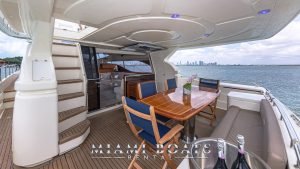 Aft Deck of the 70' Ferretti Luxury Yacht. Wooden table and chairs.