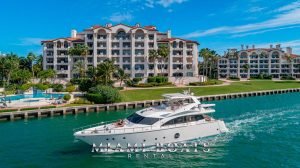 75' Aicon Flybridge luxury yacht cruising along the shore of Miami Beach.