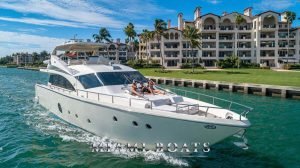 75' Aicon Luxury yacht with people laying on the bow cruising along the shore.