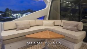 L-shaped Couch and wooden table on the aft deck of the 86' Azimut Sport yacht.