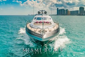 92 ft Mangusta Luxury Yacht splashing Atlantic Ocean. View from the front. Miami Downtown on the background.