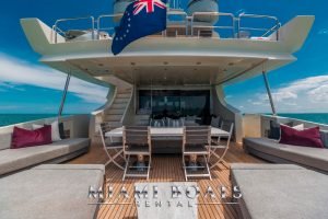 The aft deck of super Yacht Azimut 130'. The image of the aft deck shows two sun beds and the table with four chairs