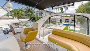 The image of the flybridge of the 41' Meridina Yacht with cushions and Captain sit.