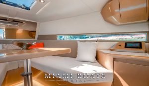 Rest area of the 36 ft Canrad yacht. White couch and pillow.
