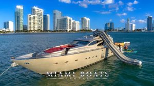 Miami Yacht and Rental Boat Services. Chartered yacht Pershing Regal 90 foot in Miami water. On the background is Miami Downtown
