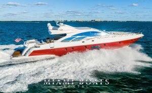 86' Azimut Yacht Sport is a luxury yacht in Miami, the perfect design and combination of red and white color of exterior design mirroring the ocean dark blue water white, the yacht speeding on the Atlantic Ocean and spreading the waves around. Side view of the boat