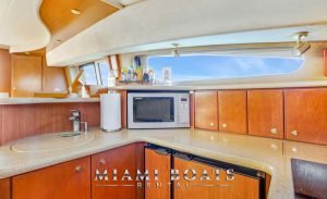 Kitchen of the 45' Silverton yacht. Wooden cabinets and marble countertop.