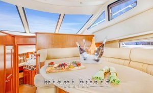 Cheese board and champagne bottles in a bucket served on the living room table of the 45' Silvrton yacht.
