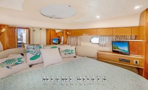 The bedroom of the Viking Yacht princess 60ft with pastel color bedsheets and pillows