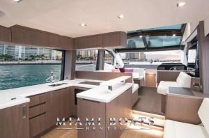 The kitchen area of the Galeon Yacht. The inside of the boat wooden flooring and modern interior design, with marble kitchen top.
