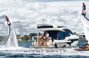 510 Galeon SKY Yacht in Miami on the water. People enjoying yacht charter in Miami with most coolers water-toys such as Jet-Skis and Flyboarding.