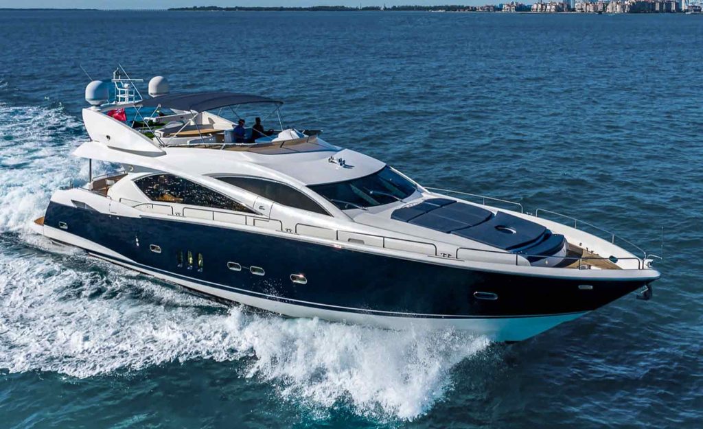 Image of Luxury Yacht Sunseeker Manhattan driving fast in the ocean in Miami. The yacht is 82 ft and open for events and any celebration. The luxury yacht Sunseeker listed for yacht charter in Miami at Miami Boats Rental.