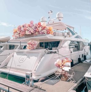 Decoration of Balloons on Super Yacht Azimut. Pink Balloons decoration on the fly bridge area of the boat at the marina