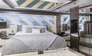The main cabin of 95' Dominator. The modern interior design of the yacht with wall closet and cold colors. Luxury Yacht in Miami