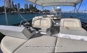 The 42' Regal Yacht Fly's spacious flybridge featuring plush seating, a well-equipped helm station, and a panoramic view of the surrounding waters.