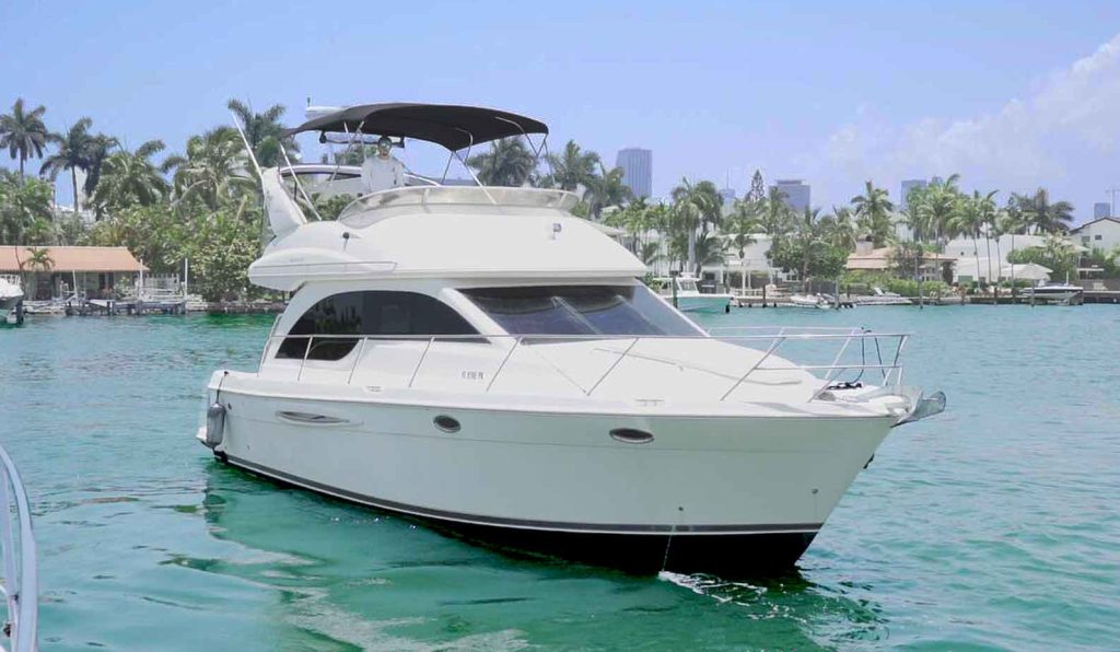 Image of the Meridian Yacht 41 feet flybridge on the water in Miami. The yacht is listed for a rental by Miami Boats Rental.
