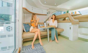 two girls sitting on the sofa in stateroom of the Sea Ray Yacht Flybridge