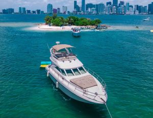 Sea Ray Yacht Flybridge in Miami. The image of the boat on the water and on the background is small island of Miami Beach