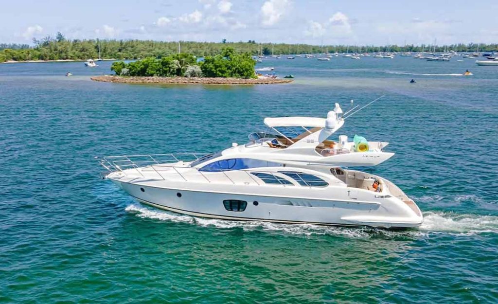 Azimut Yacht Rental MIami. Luxury Yacht 55' Azimut. White Azimut Flybridge Yacht on the water in Miami next to small picnic Islands
