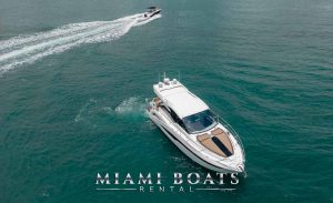 45-ft Galeon Yacht on the water and small boat driving behind