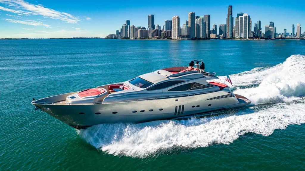 Luxury yacht 90' Pershing regal sailing in the Miami Ocean with Miami Downtown on the background