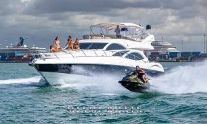 During the yacht rental in Miami People are enjoying Jet Ski ride and dancing on the bow of the yacht
