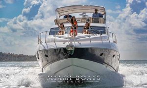743' Sunseeker Luxury yacht Manhattan driving on the water in Miami with people on the front