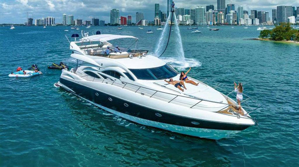 Exclusive Sunseeker Yacht Manhattan 74 ft in Miami Beach, FL. Yacht on the water in Miami and around is water toys such as jet ski, inflatable island, and flyboarding.