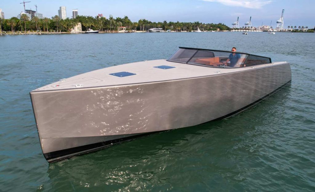 The VanDutch Yacht 56 on the water in Miami Beach. The yacht has a sleek, modern design and is powered by twin Mercury Verado engines.